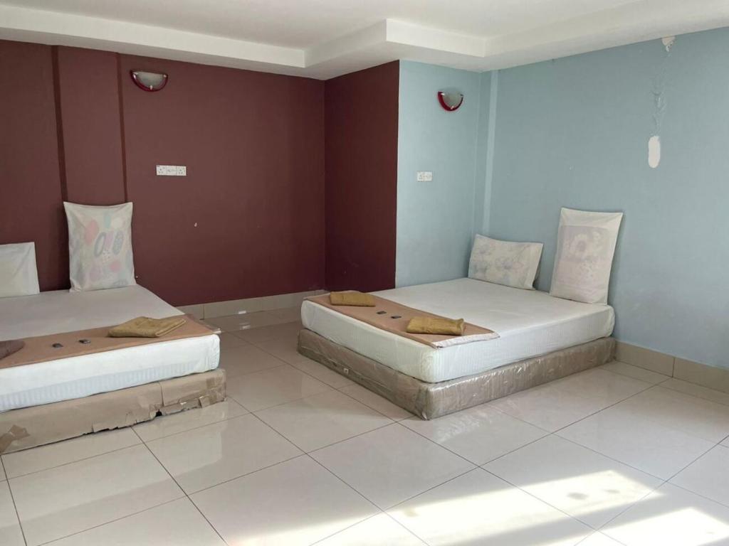 Postel nebo postele na pokoji v ubytování SV Andalas Hotel