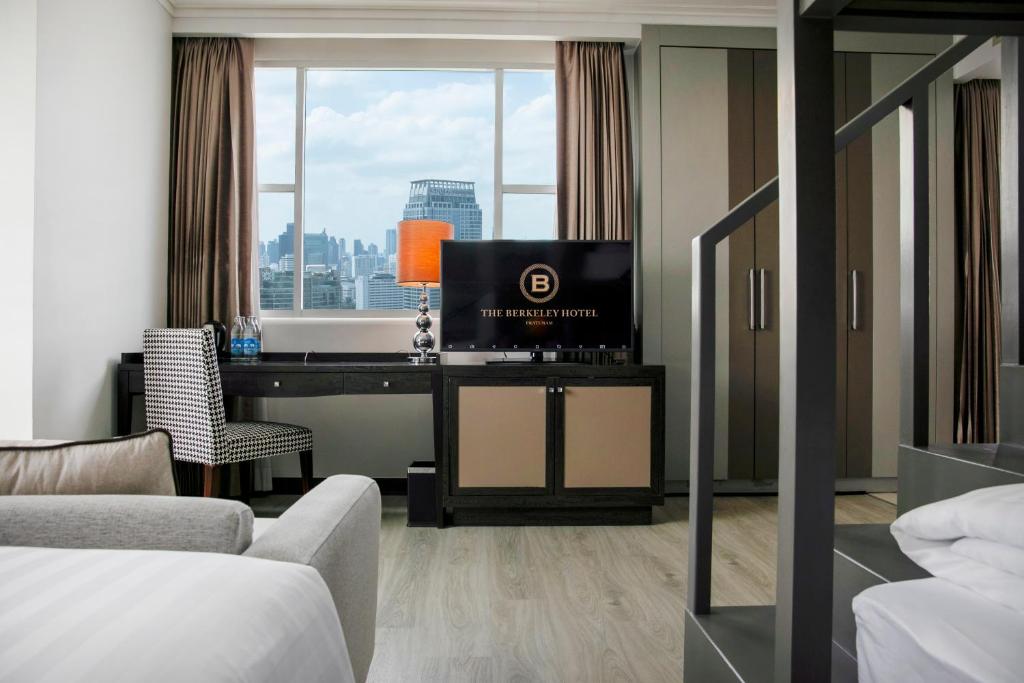 a hotel room with a desk with a television on it at The Berkeley Hotel Pratunam in Bangkok