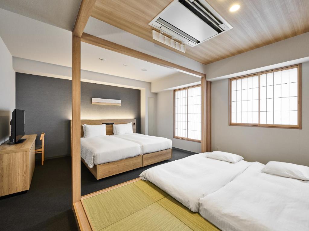 Postel nebo postele na pokoji v ubytování MIMARU Tokyo Akasaka