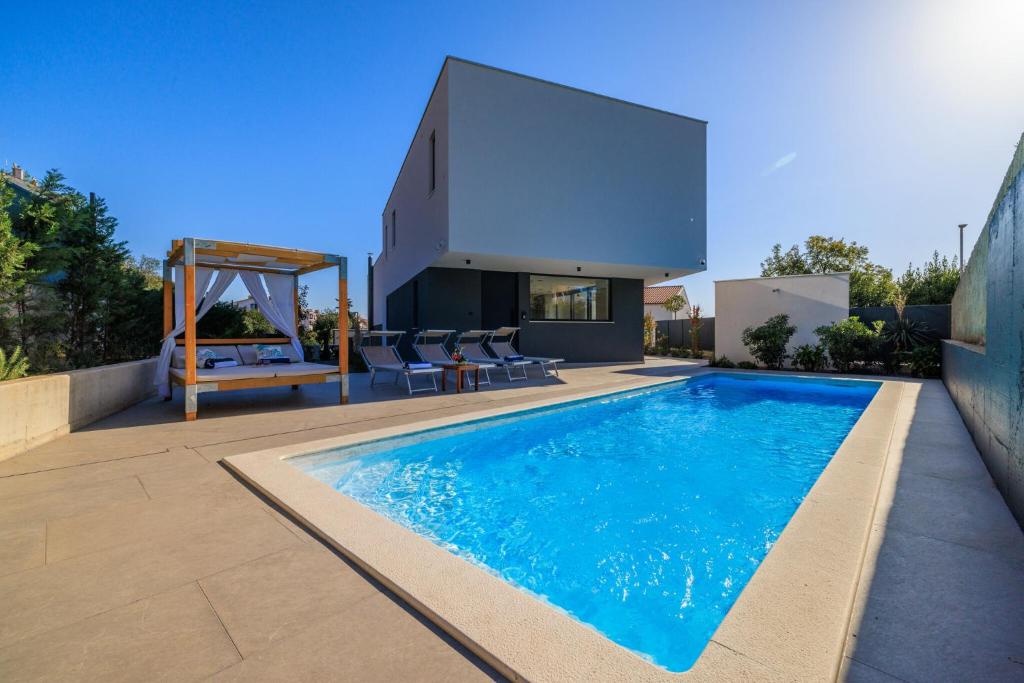 a swimming pool in the backyard of a house at Villa Vista Maris in Crikvenica