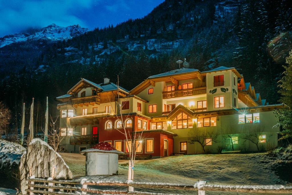 a large house in the mountains at night at Pirker's Natur- & Bio Familienhotel in Malta
