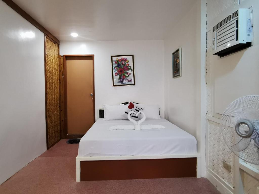 Postel nebo postele na pokoji v ubytování Kimura Beachfront El Nido