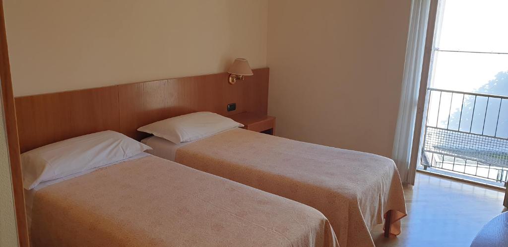 Postel nebo postele na pokoji v ubytování Hotel Tre Re