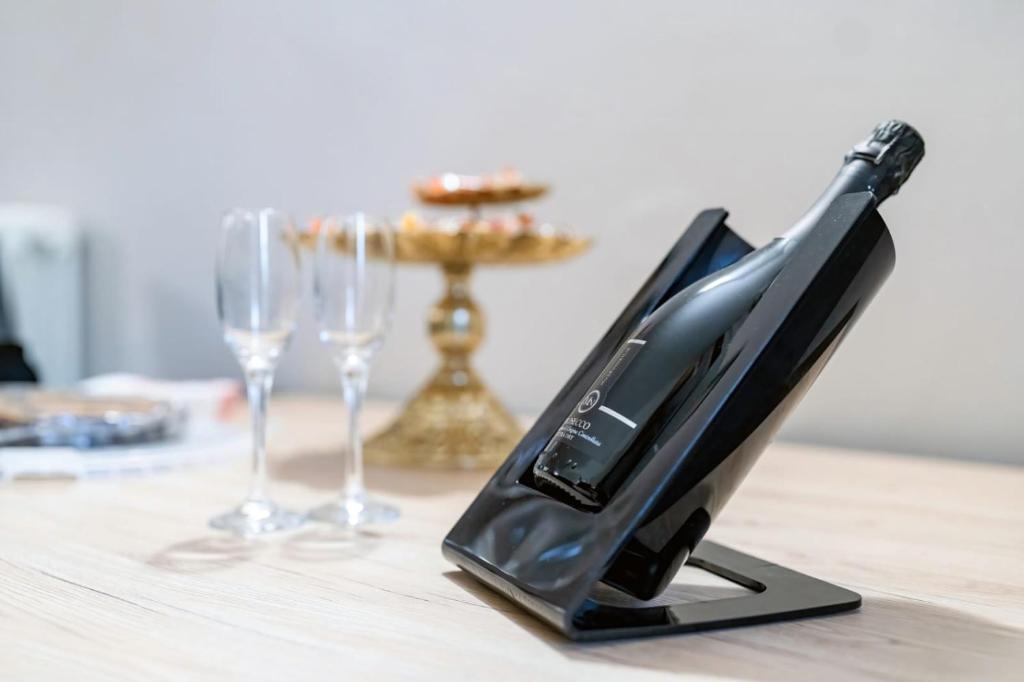 a black appliance sitting on a table with wine glasses at Bonsai B&B in Verona