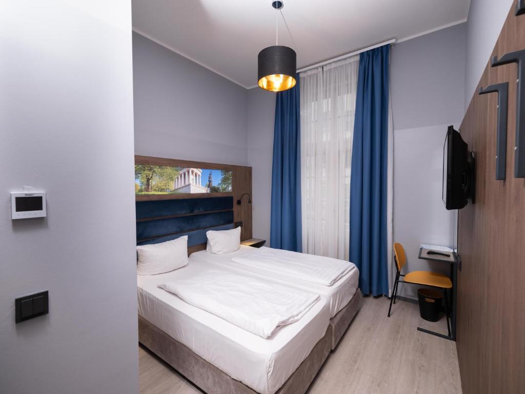 Postel nebo postele na pokoji v ubytování Smart Stay Hotel Station