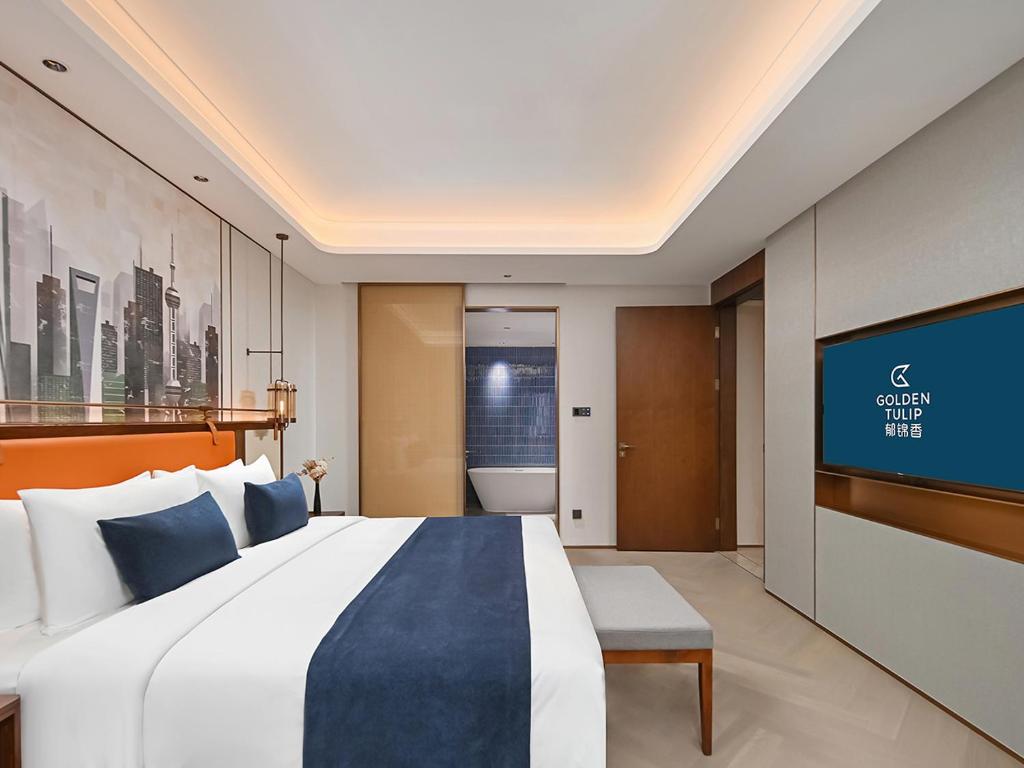 Postel nebo postele na pokoji v ubytování Shanghai Hongqiao Yankuang Tulip Hotel