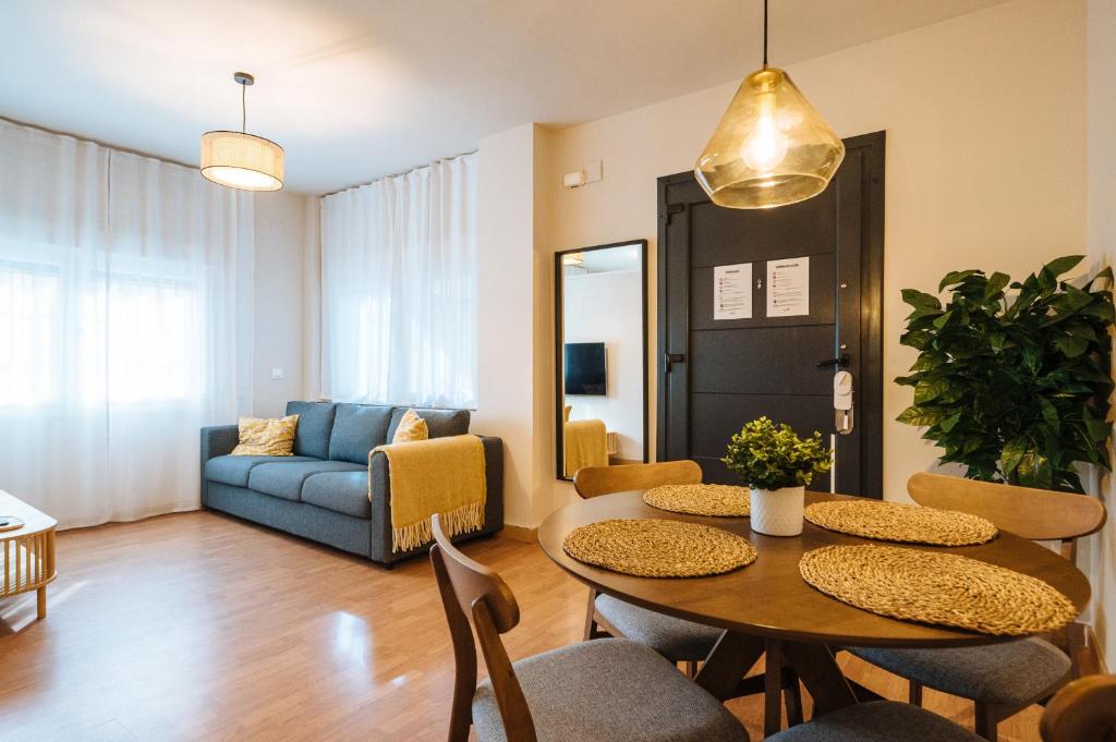a living room with a table and chairs and a couch at Charming Apartment in the Heart of Triana, Seville in Seville