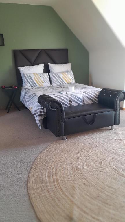 a bed with a leather frame in a bedroom at Cossy Possy Guest House in Johannesburg