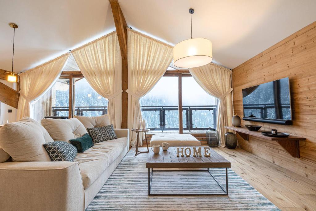un salon avec un canapé et une table dans l'établissement Superb flat - Domaine de lariondaz New, à Saint-Bon-Tarentaise