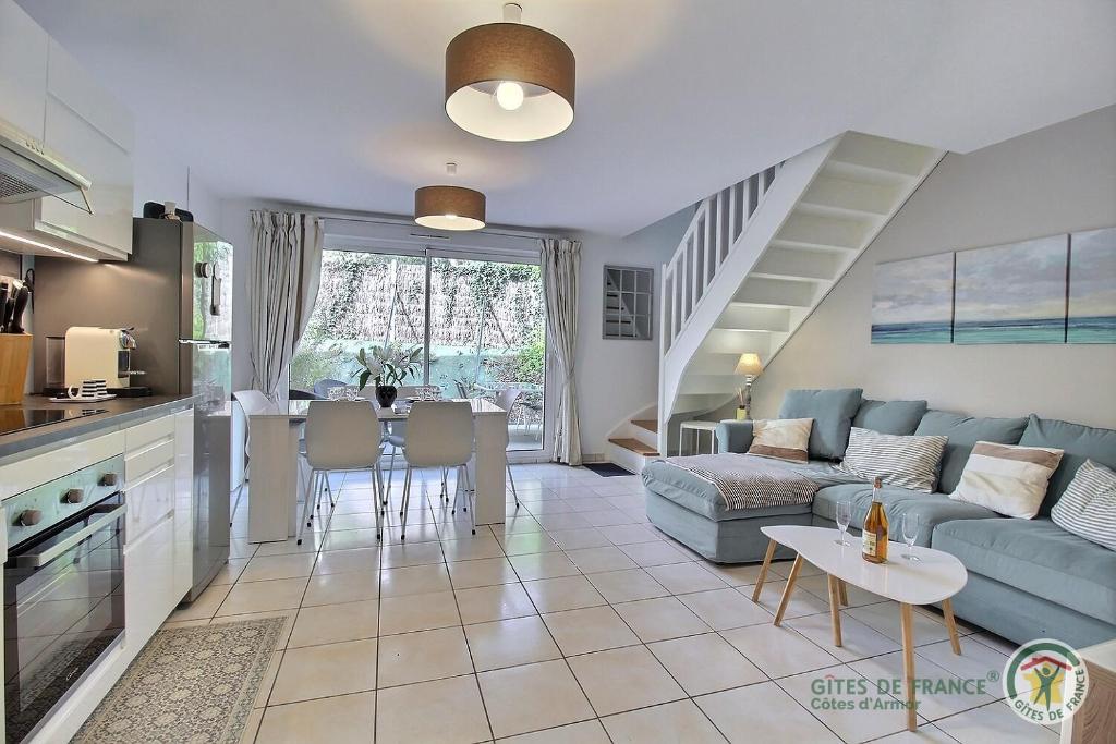 a living room with a couch and a table at Maison six in Pléneuf-Val-André