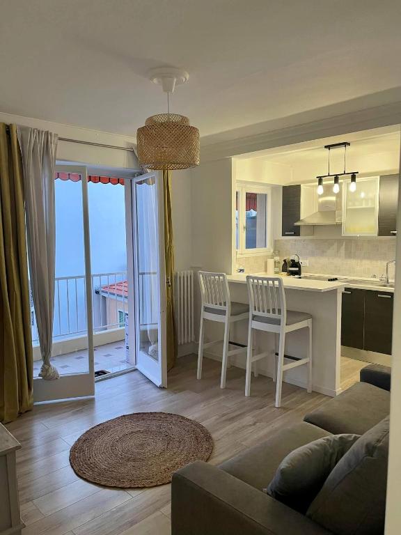 une cuisine et un salon avec une table et des chaises dans l'établissement Joli Nid, à Menton
