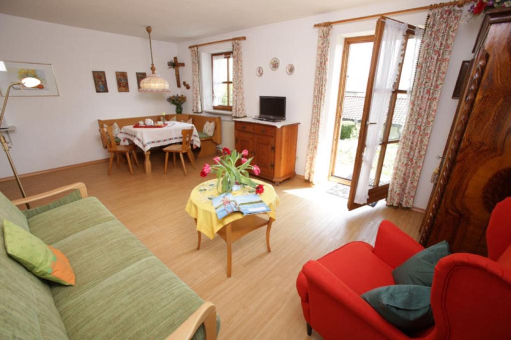 a living room with a couch and a table at Landhaus Kauderer - Wohnung 1 in Waging am See