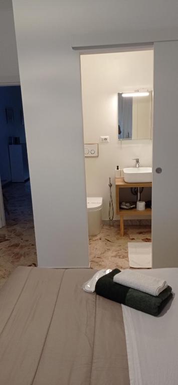 a bathroom with a bed and a sink at CasaRA in Bari