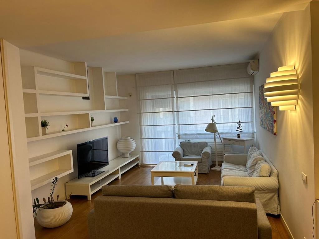 a living room with a couch and a tv at Piccinni Exclusive Suite 182 in Bari