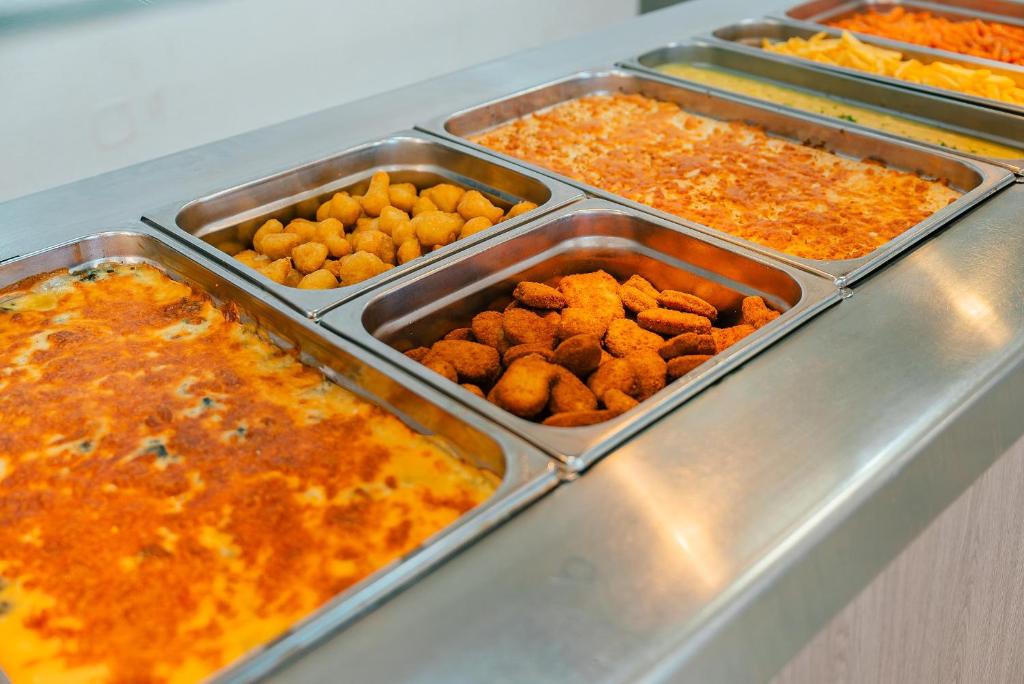 a buffet with several trays of food on a counter at Port Europa in Calpe