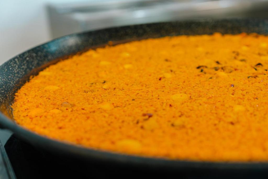 a pan filled with orange soup on a stove at Port Europa in Calpe
