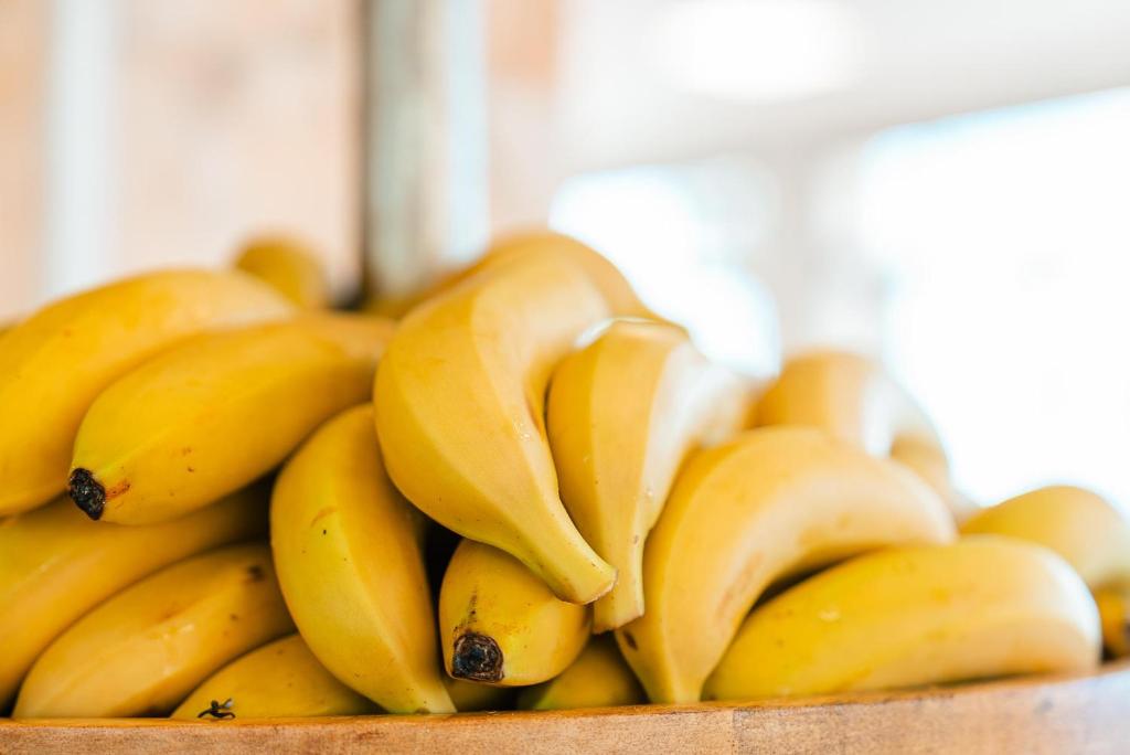 a bunch of bananas sitting in a wooden box at Port Europa in Calpe