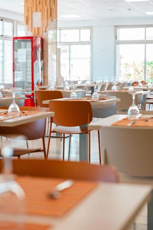 an empty dining room with tables and chairs at Port Europa in Calpe