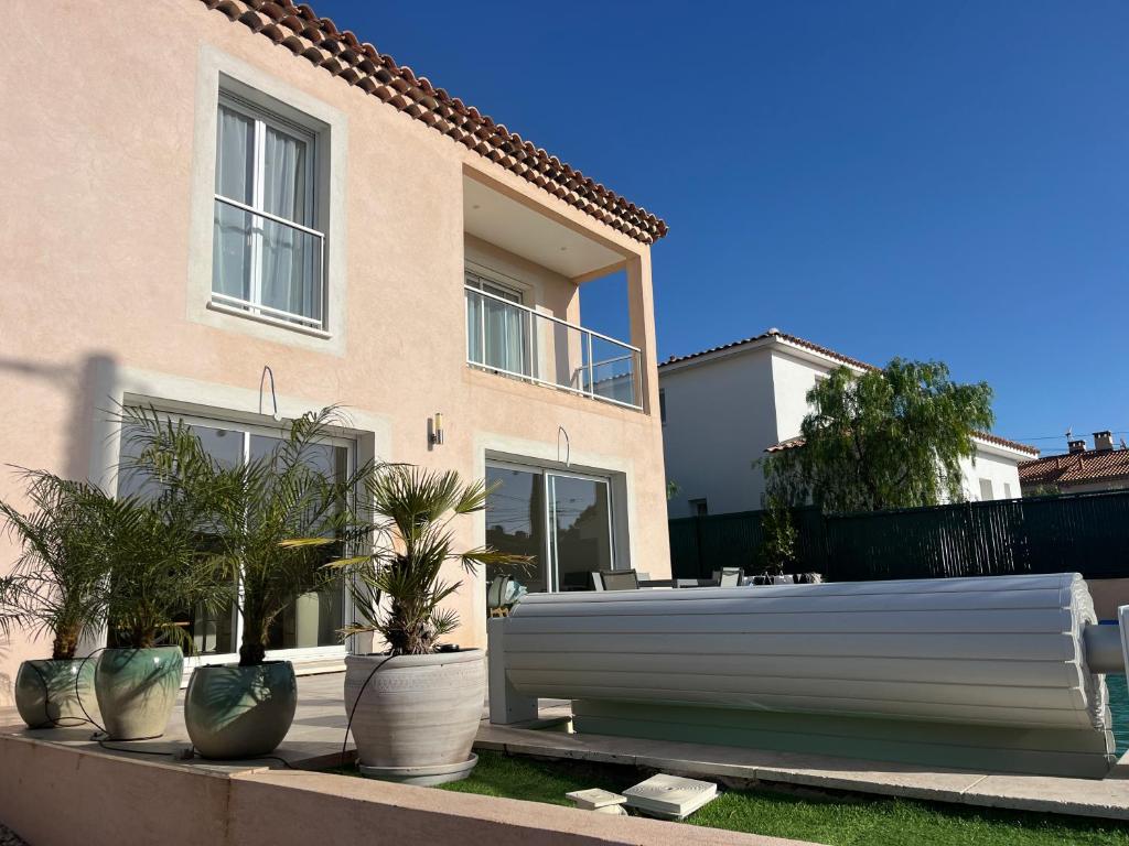 une maison avec des plantes en pots devant elle dans l'établissement Villa Ischia Vue Mer, à Bandol