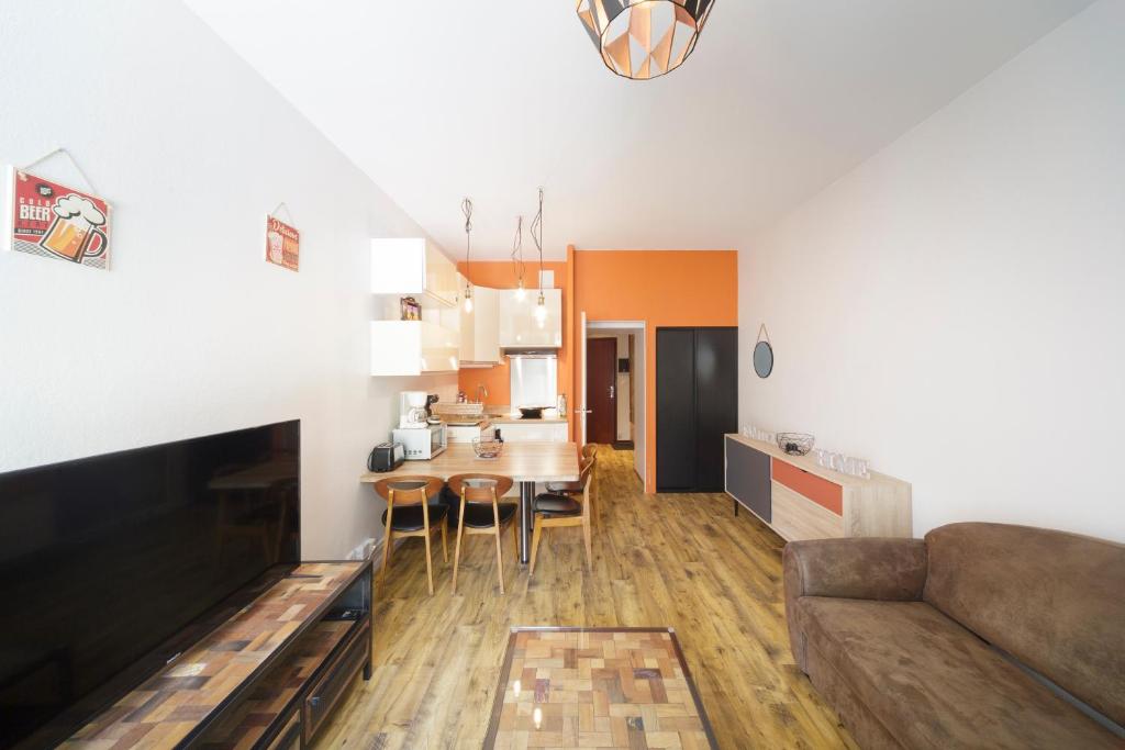 a living room with a couch and a table at Ô Cocon - Station de ski à pied vue montagne in Eaux-Bonnes