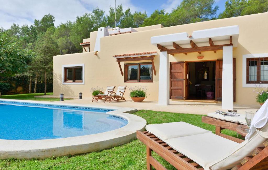 a villa with a swimming pool and a house at Villa El Abuelo in Santa Eularia des Riu