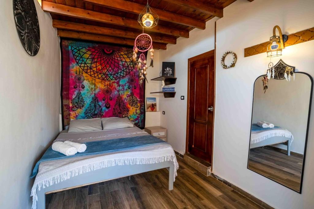 a bedroom with a bed and a large mirror at Dream Catcher in Dahab