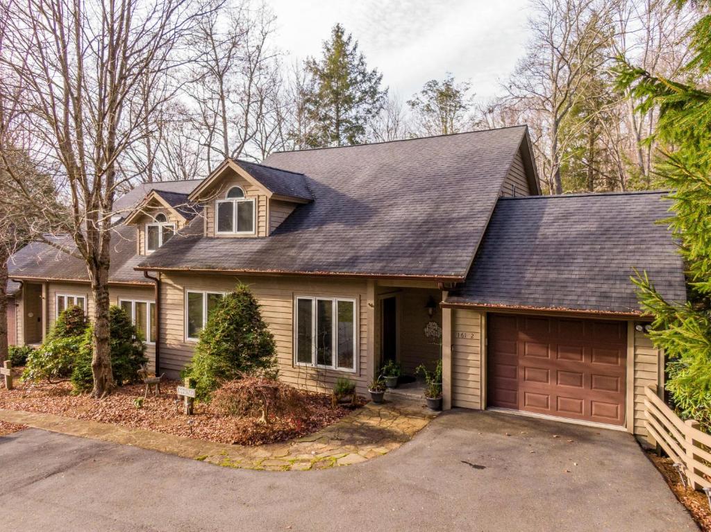 a house with a driveway and a garage at Sylvan Falls at Yonahlossee in Blowing Rock