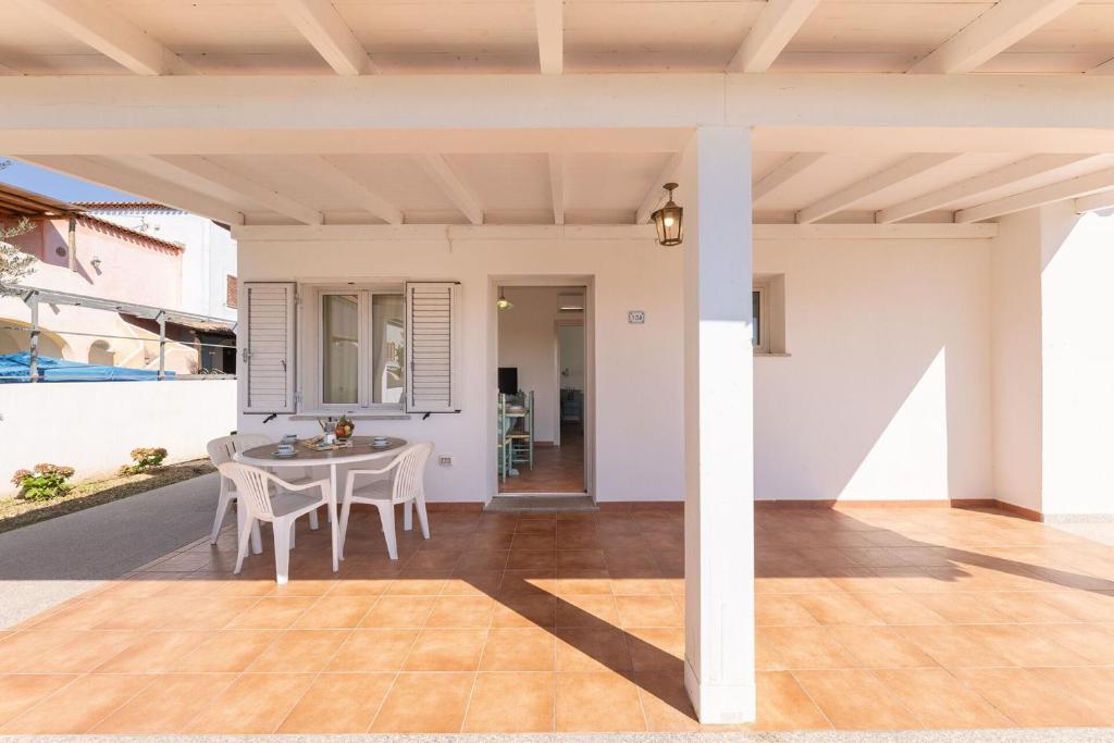 an outdoor patio with a table and chairs at Apartments In Golfo Orosei in Orosei