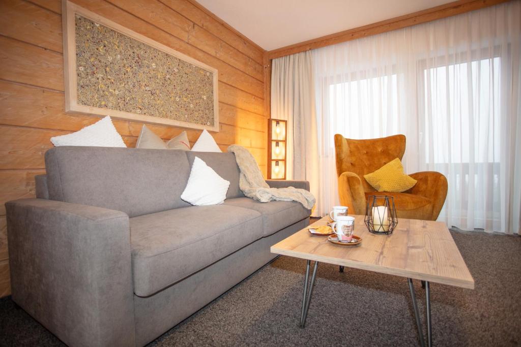 a living room with a couch and a coffee table at Alpenperle in Berwang