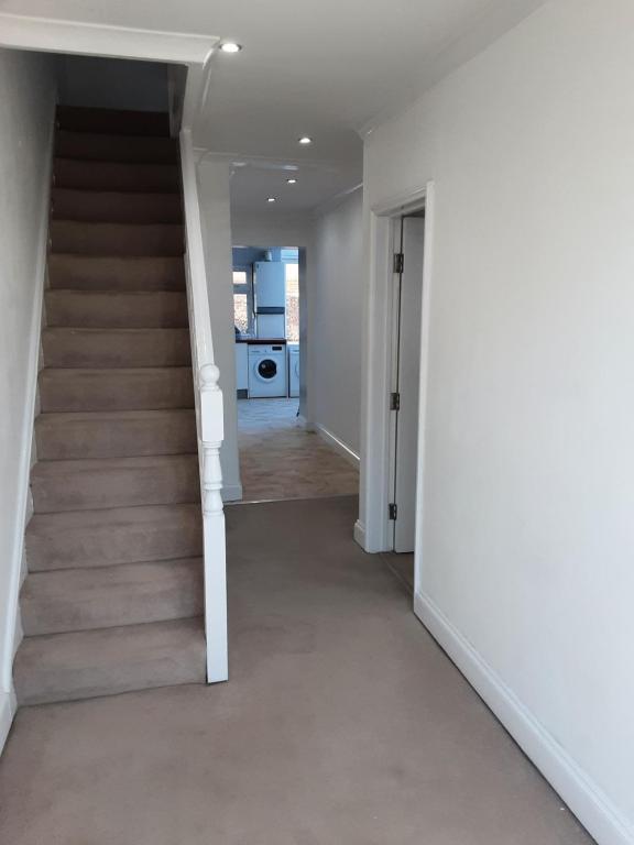 an empty hallway with stairs in a house at Mirandas Place in Gillingham