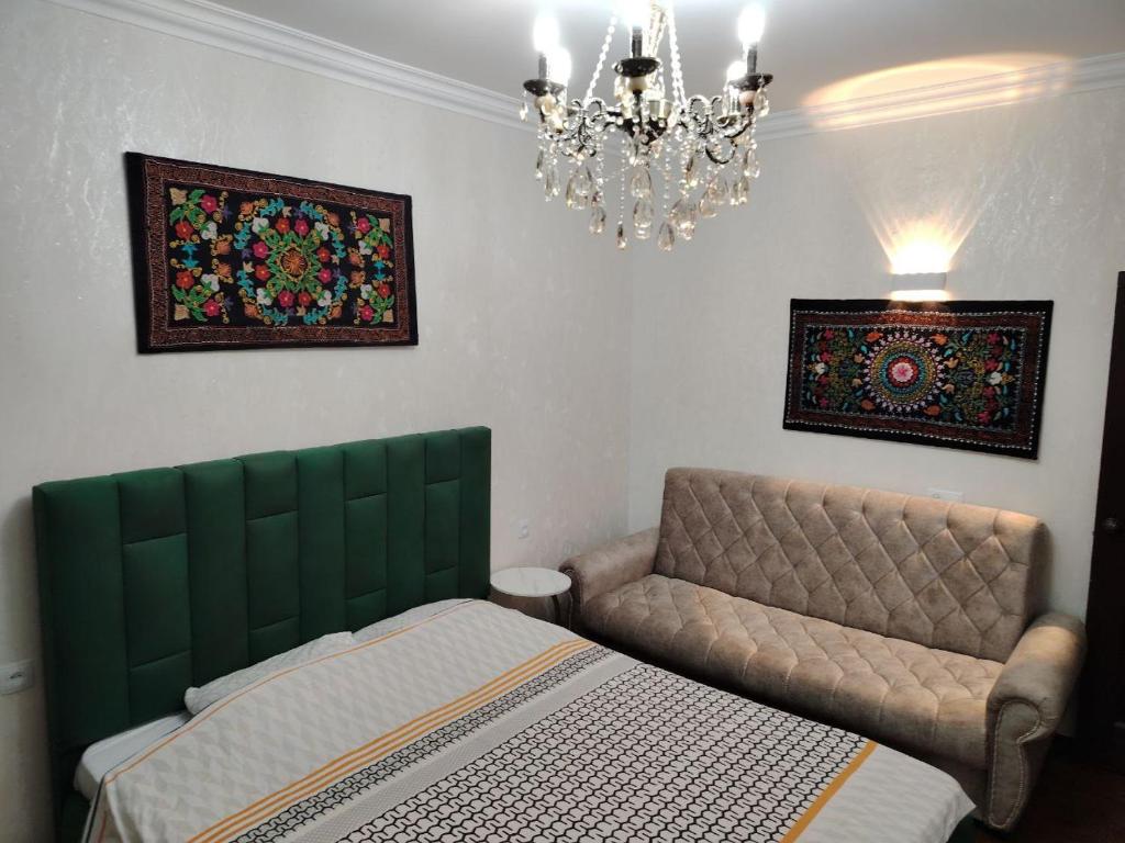 Ένα ή περισσότερα κρεβάτια σε δωμάτιο στο Apart Tashkent