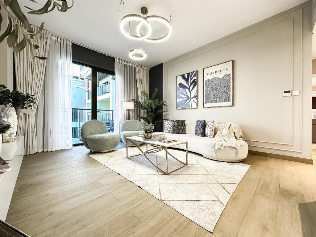 a living room with a couch and a table at Trophy - Beach Daze Condo in Lamer W Sea Views in Dubai