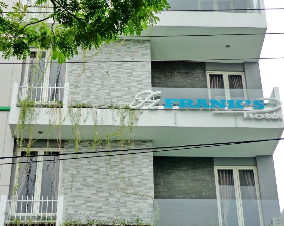 a building with a sign on the side of it at Frank's Hotel in Surabaya