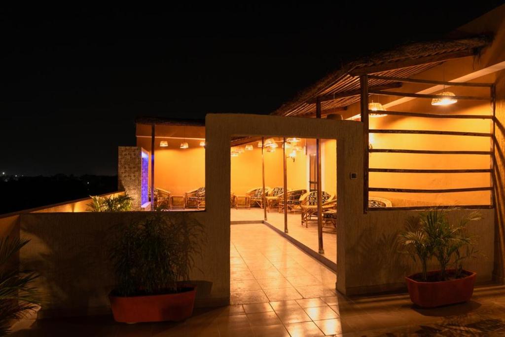 a house with a lit up patio at night at Airport INN Hotel in Lomé