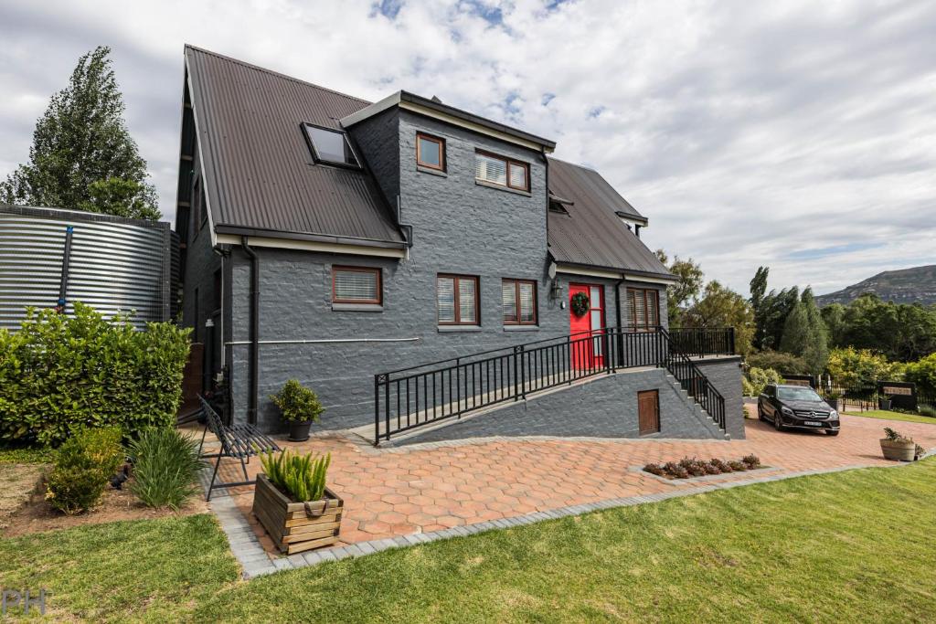 a house with a red door and a driveway at The Red Door in Clarens