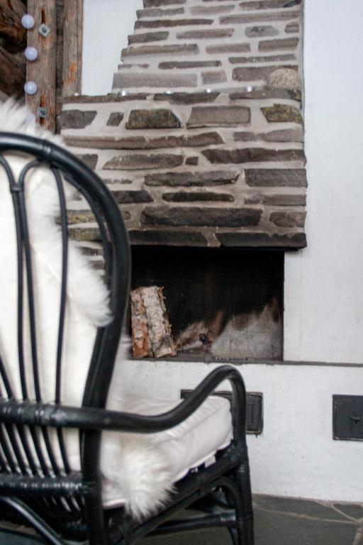 a chair sitting in front of a brick fireplace at Vuokatinportintie in Vuokatti