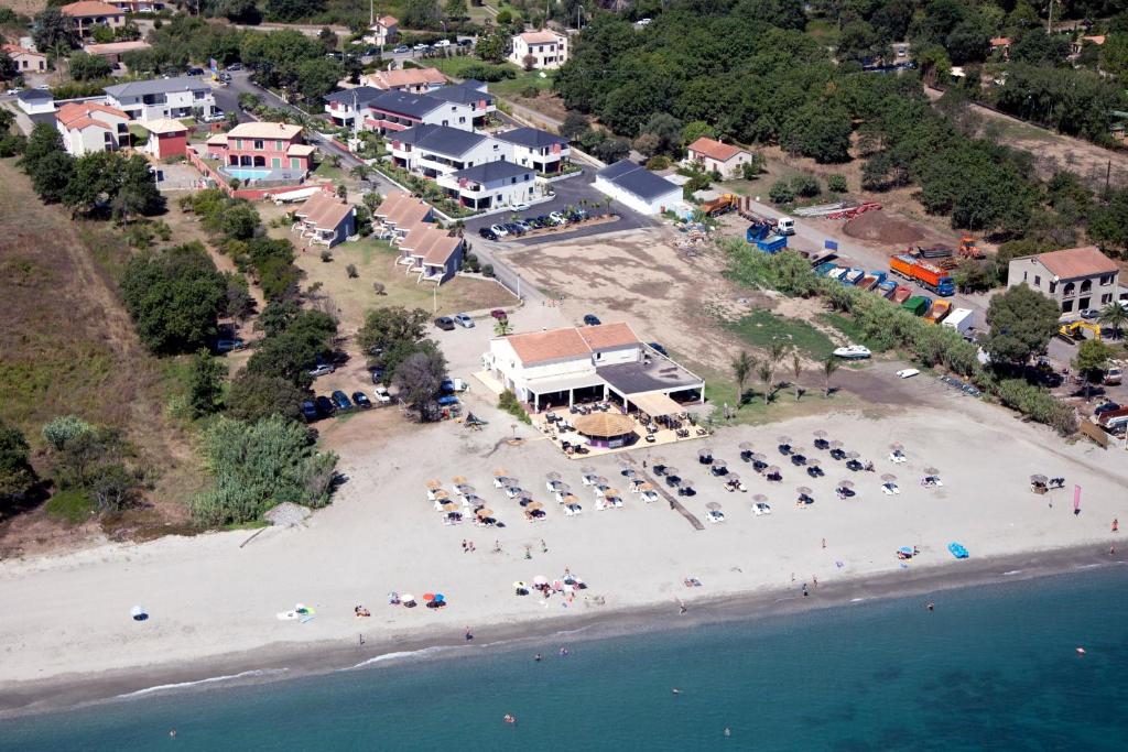 an aerial view of a beach with chairs and umbrellas at Bungalow on the sea - Moriani beach in Santa-Lucia-di-Moriani