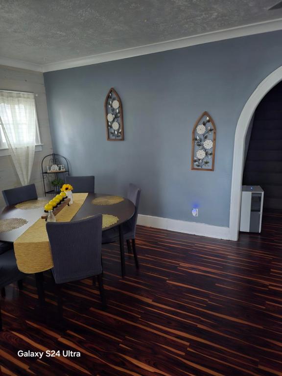 a dining room with a table and chairs and a blue wall at Leisure guest home in Lorain