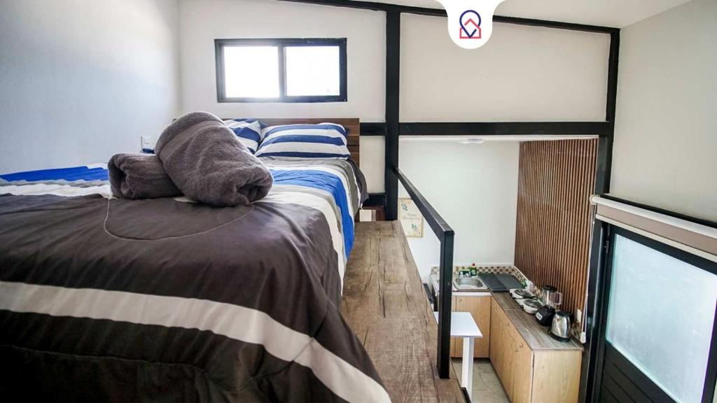 a bedroom with a large bed and a television at Lofts Tequisquiapan in San Luis Potosí
