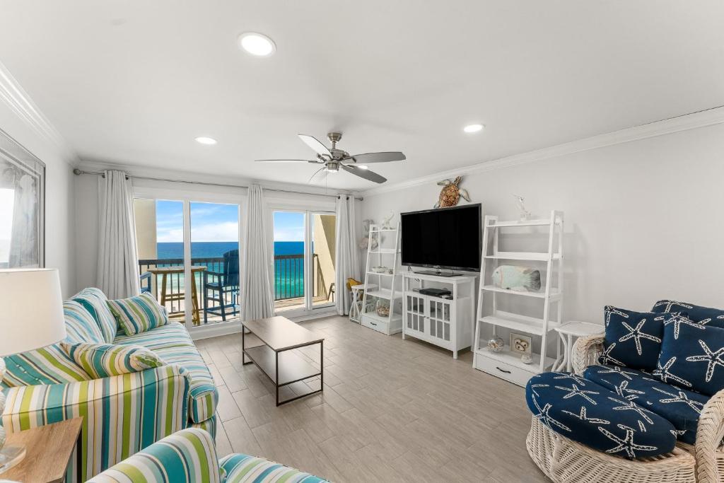 a living room with a couch and chairs and a television at Beautiful Beach Front Paradise at Pinnacle Port B2-608! in Panama City Beach