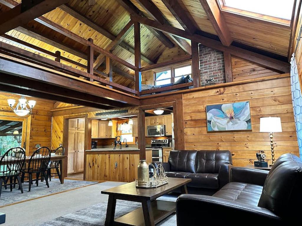 a living room with a couch and a table at Forest Tree Log Cabin in Middletown