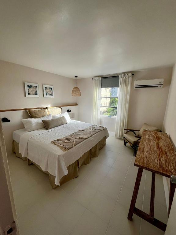 a bedroom with a large bed and a window at The Monteray Hotel in Christ Church