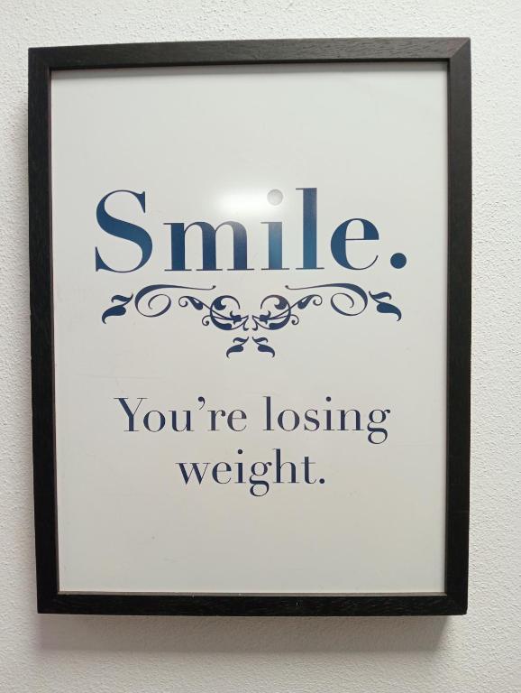a framed picture of a smile youre losing weight at B&B Franciacorta in Castrezatto