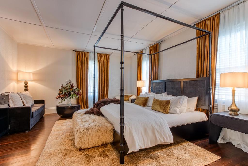 a bedroom with a four poster bed and a couch at Doctor Sax House in Lenox