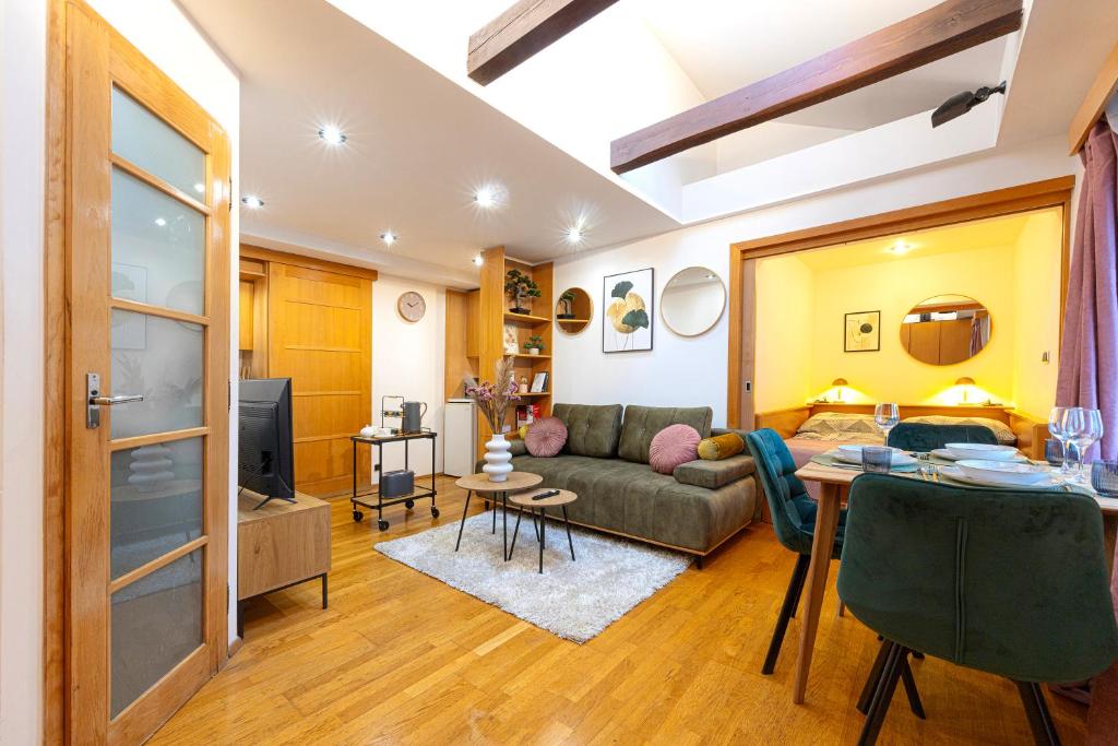 a living room with a couch and a table at The Wenceslas Loft in Prague