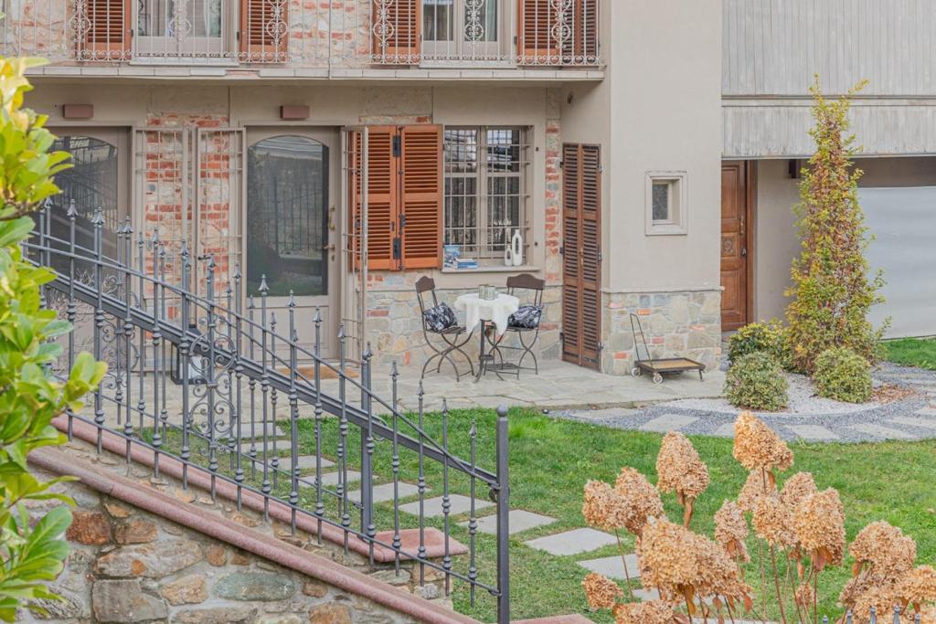 a house with a patio and a table in the yard at Frabosa Relax Garden- PVT Parking -10 Min Ski Station in Frabosa Sottana