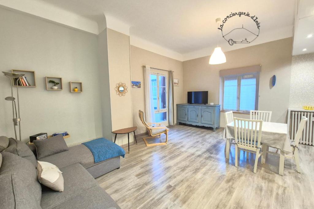 a living room with a couch and a table at La Marquise #Garage#Therme in Royat