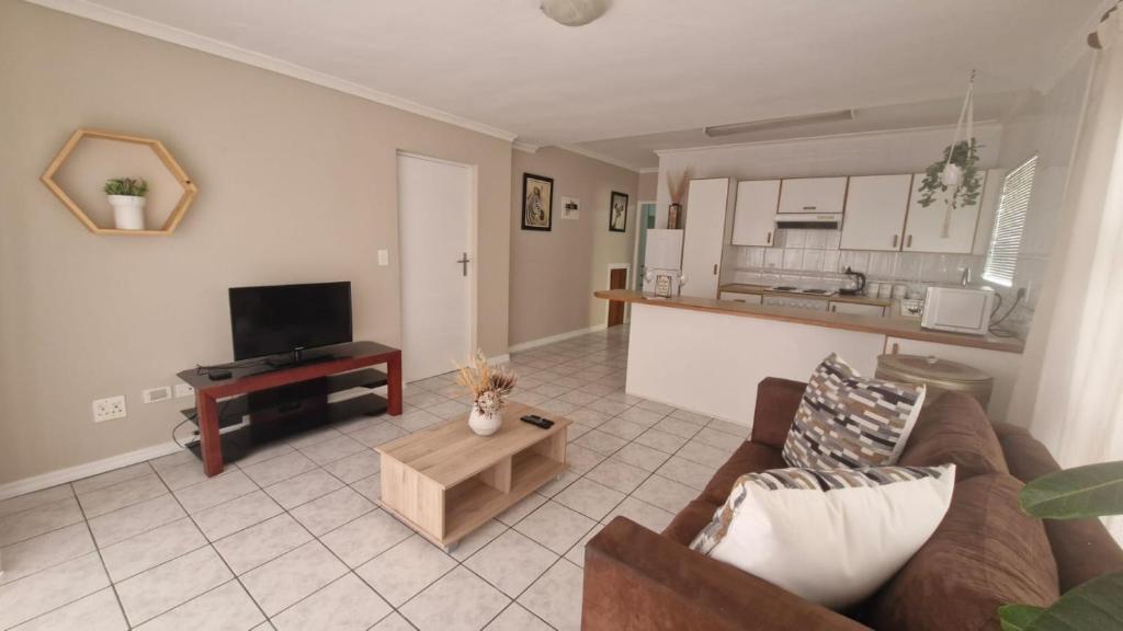 a living room with a couch and a table at Knysna Nessie in Knysna