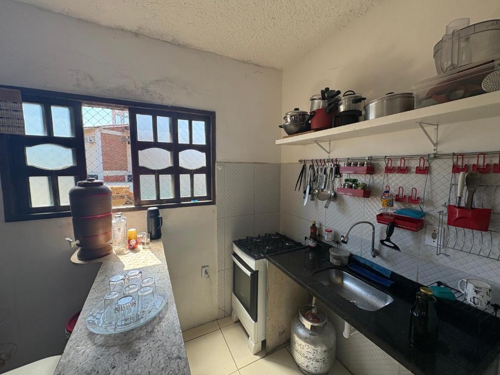 a small kitchen with a sink and a stove at Gest House in Niterói