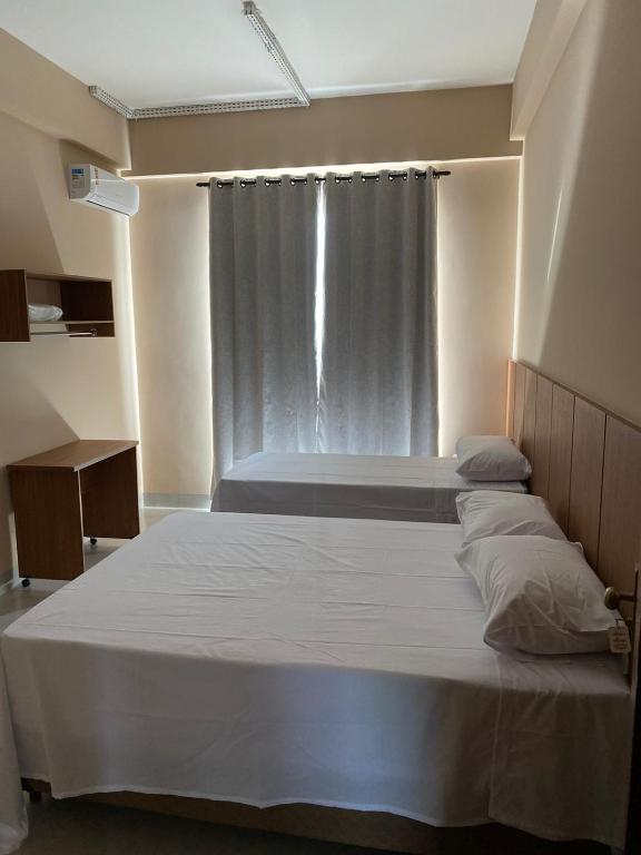 a bedroom with two beds and a window at Hotel Primavera Palace in Salinas